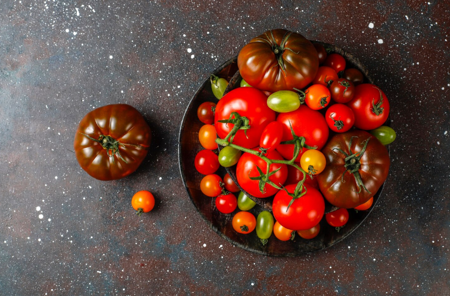 Mixed heirloom tomatoes in a bowl, once considered dangerous to eat.