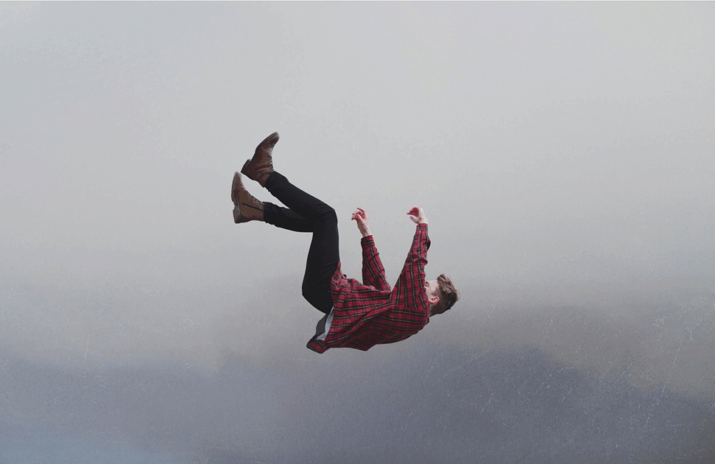 Person mid-air in a controlled freefall, visualizing invisible forces in everyday life like gravity