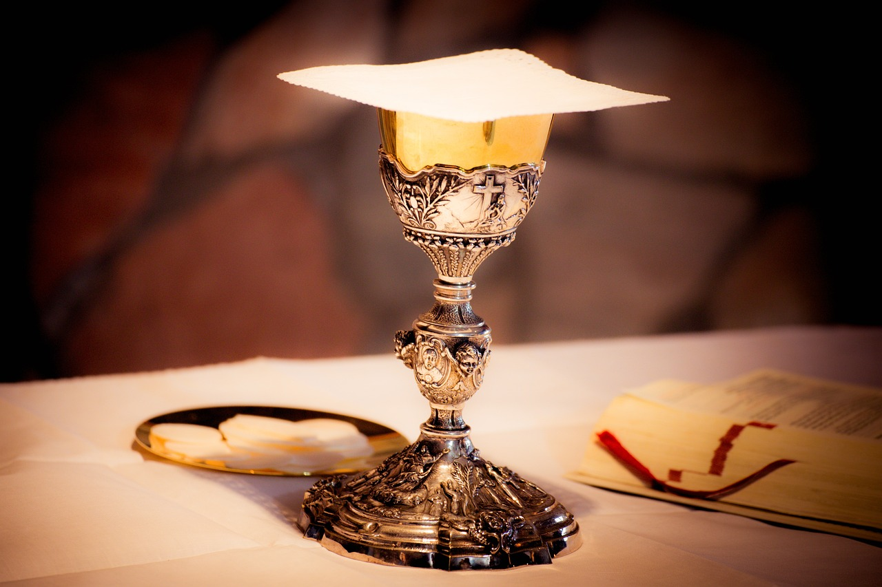Ornate silver-and-gold chalice with a communion host, symbolizing the legendary Holy Grail.