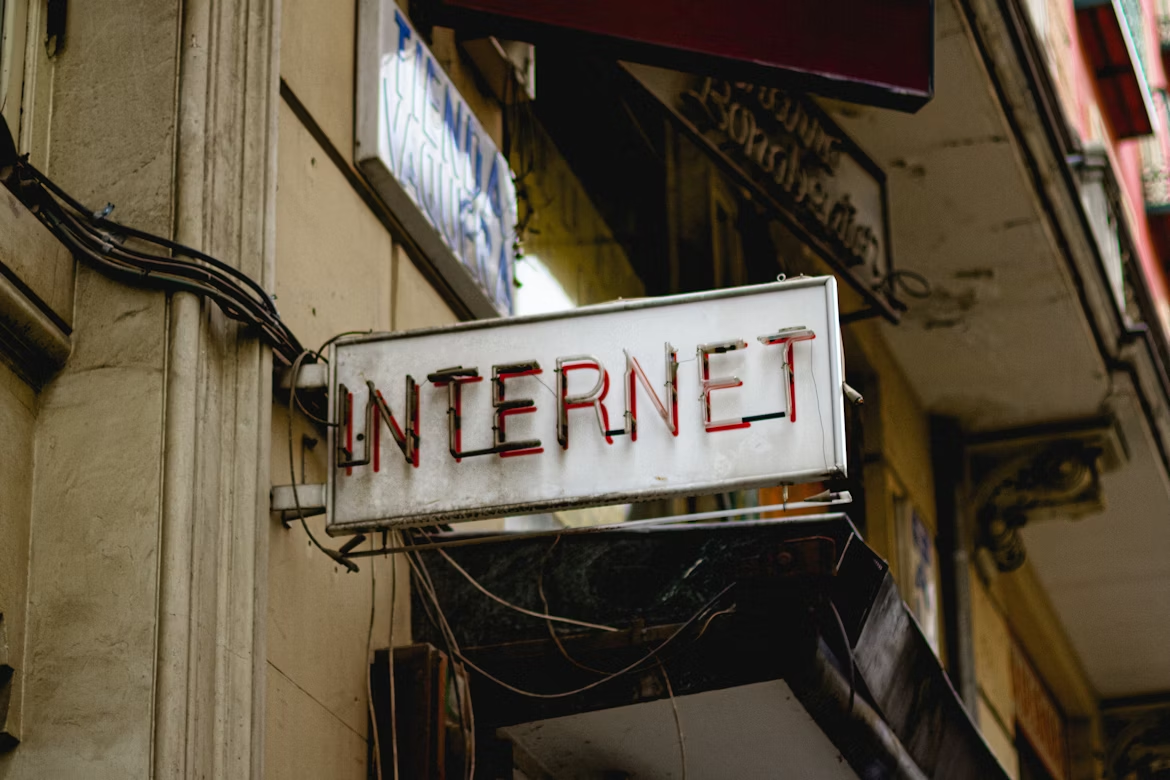 Weathered neon “Internet” sign, evoking online access and outage stories.