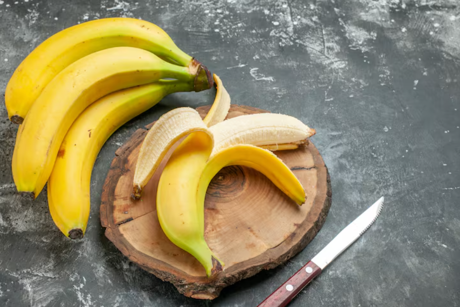 Peeled banana on a wooden board